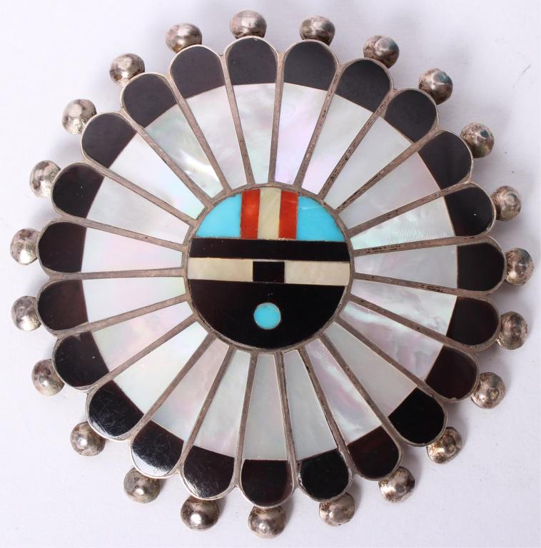 ZUNI STERLING SILVER BROOCH PENDANT W/ TURQUOISE: ZUNI STERLING SILVER BROOCH PENDANT W/ TURQUOISE Zuni Indian sterling silver brooch / pendant with turquoise, MOP, onyx, and coral. Etched on reverse "Adrian and Elizabeth Wallace- Zuni" Weight: 28.5 