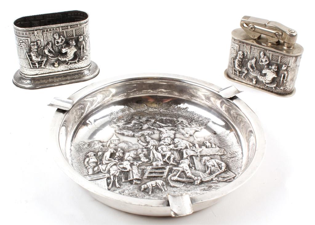 SPRITZER FUHRMANN GERMAN REPOUSSE ITEMS - LOT OF 3: SPRITZER FUHRMANN GERMAN REPOUSSE ITEMS - LOT OF 3 Silver plated items by Spritzer & Fuhrmann of Germany to include an ashtray (7.5 inches), table lighter sleeve (3 inches), and a table lighter (3 inc