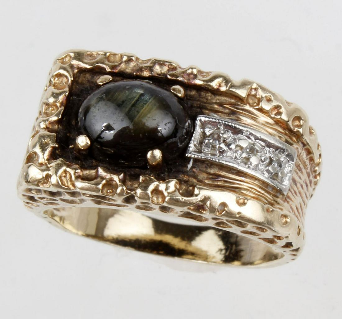 10K YELLOW GOLD BLACK STAR LADIES RING: 10k yellow gold 9mm x 7mm oval black star gemstone with diamond accents. Weight: 6.9 g Size: 7 Condition: Very Fine.