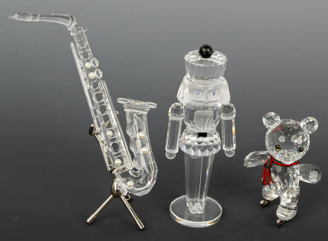 SWAROVSKI SILVER CRYSTAL - LOT OF THREE: Swarovski Silver Crystal collection lot of 3 to include: #7475-000 Nutcracker, #7637-000 Kris Bear on Skates, and #7477-007 Saxophone. Size: 2" to 4" Condition: Very Fine.