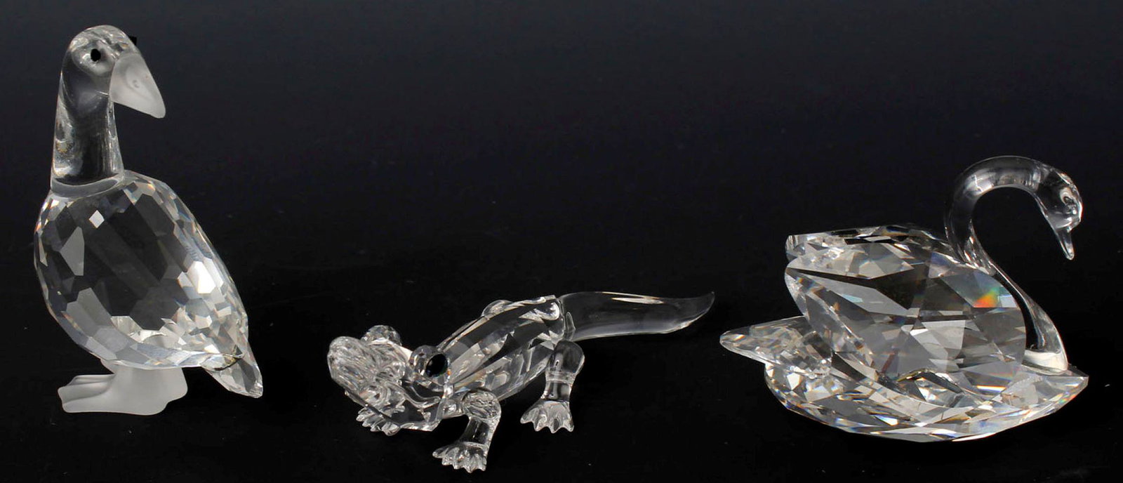 SWAROVSKI SILVER CRYSTAL - LOT OF THREE: Swarovski Silver Crystal Figurines collection lot of three to include: #7661 Alligator, #7613 Mother Goose, and #7633 Swan. Size: 2" to 3" Condition: Very Fine.