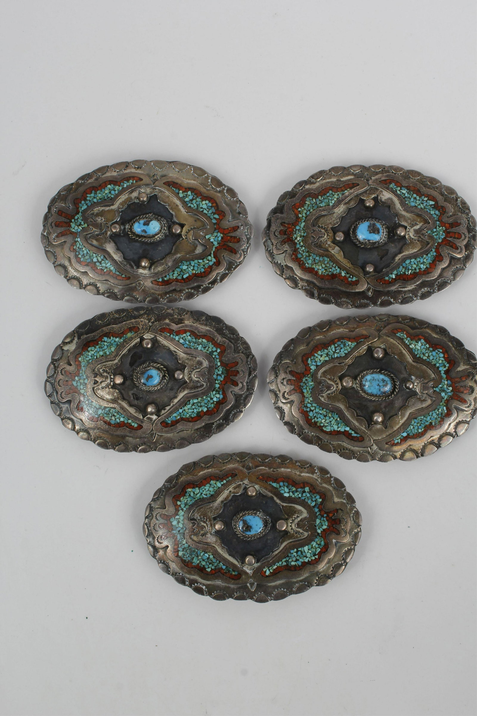 NAVAJO STERLING SILVER TURQUOISE CORAL BUCKLES: Navajo Sterling Silver turquoise and coral belt buckles lot of 4. Sterling silver with copper back clasps. Weight: 310.6 gr Condition: Very Fine.