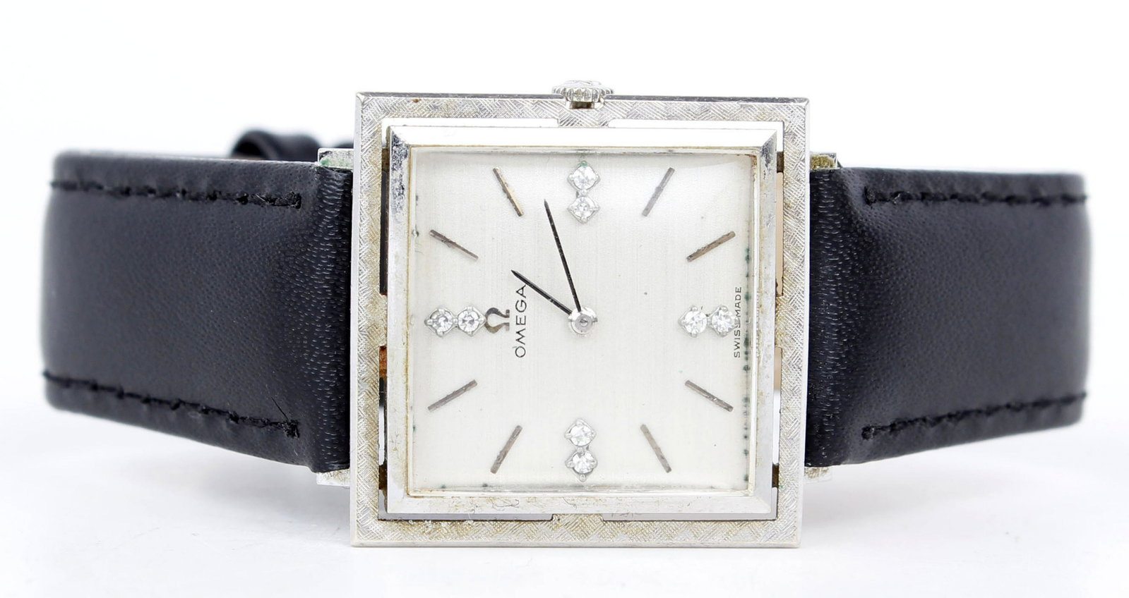 14K WHITE GOLD DIAMOND OMEGA SQUARE WRISTWATCH: 14k white gold diamond Omega square face wristwatch. 27mm square, (8) .01ct round diamond accents. Leather strap. Weight: 22.45 grams Condition: Very Fine.