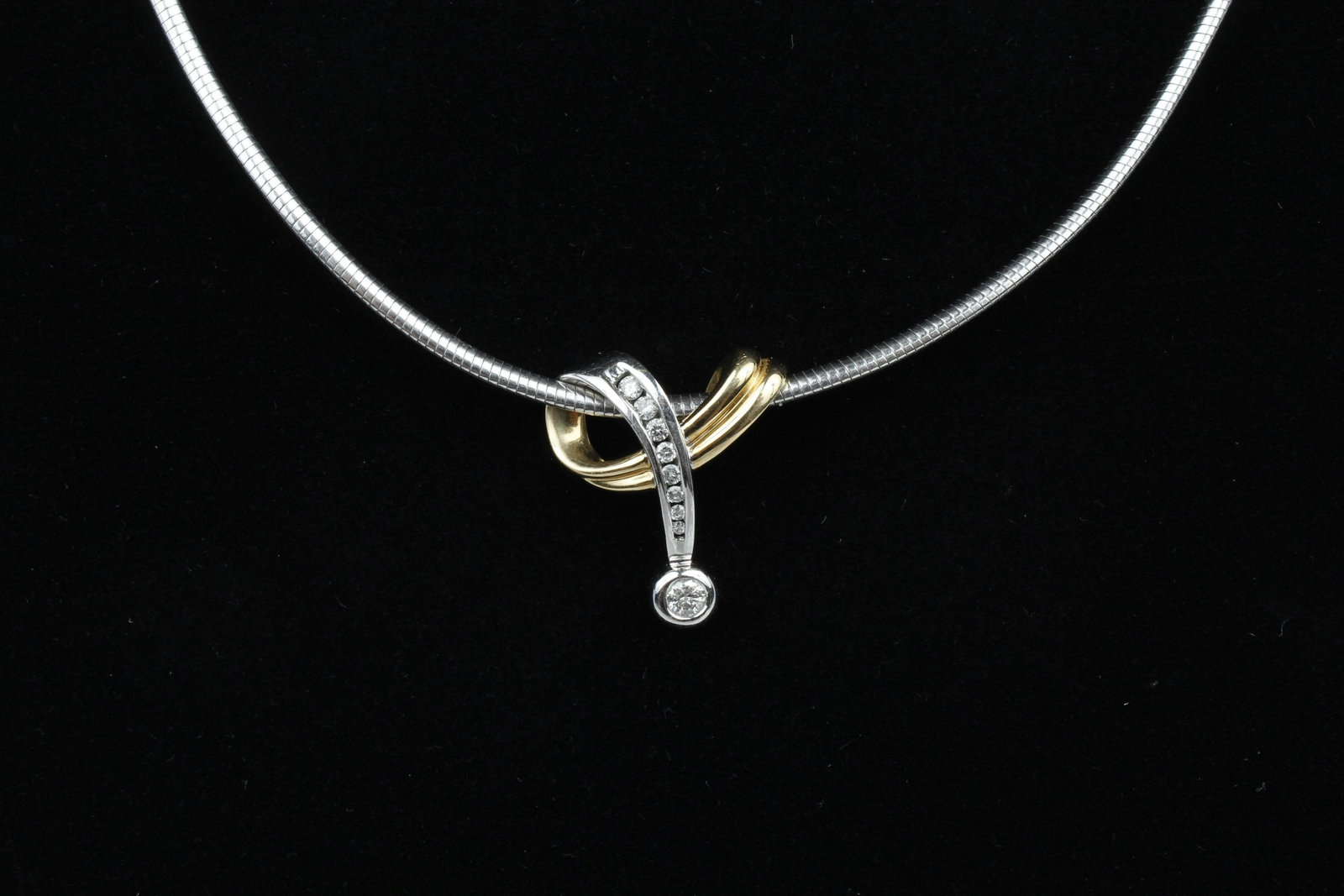 14K AND PLATINUM DIAMOND SLIDE PENDANT NECKLACE: 14k two tone .45ct center diamond slide pendant weighing 4.7 grams. accompanied by platinum 3mm omega chain weighing 15.6 grams. Condition: Very Fine.