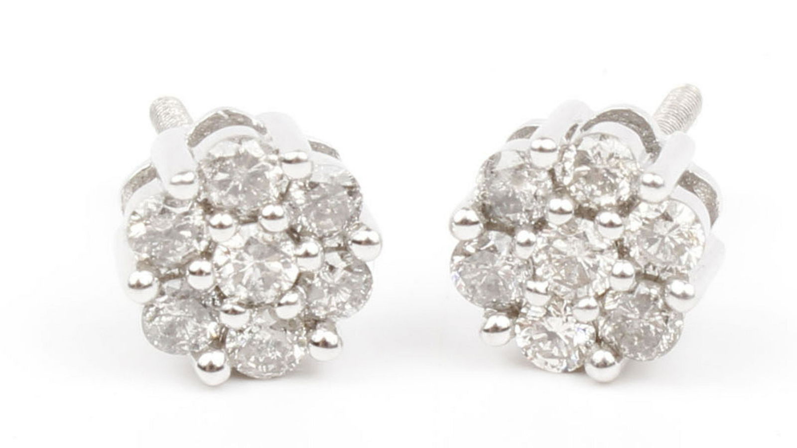 14K WHITE GOLD DIAMOND CLUSTER EARRINGS: 14k white gold diamond cluster earrings. screw back. 7 diamonds per earring. 0.07 each. ctw Weight: 2.0 Condition: very fine