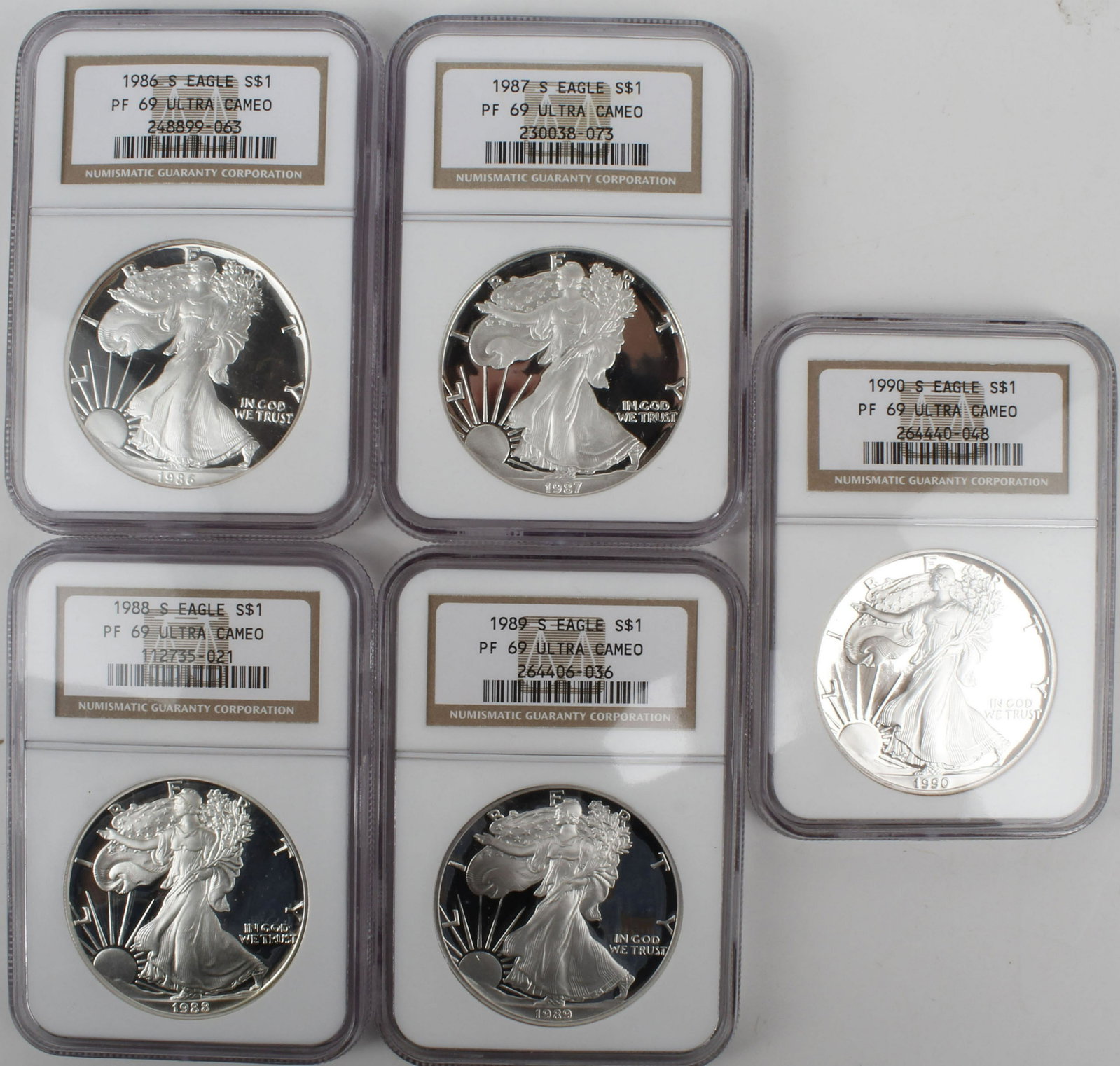 SILVER DOLLAR EAGLE - LOT OF 5 DATE RUN 1986-1990: Lot of 5 silver eagles, NGC certified. Date run including 1986 S, 1987 S, 1988 S, 1989 S, 1990 S.