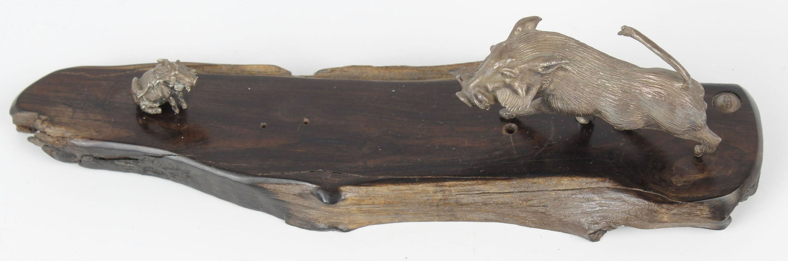 PATRICK MAVROS STERLING SILVER BOAR: A wild boar and piglet in playful stride affixed to a piece of ebonized natural wood. Each piece is properly marked by the artist. an extra set of holes indicate that perhaps a single character is mis