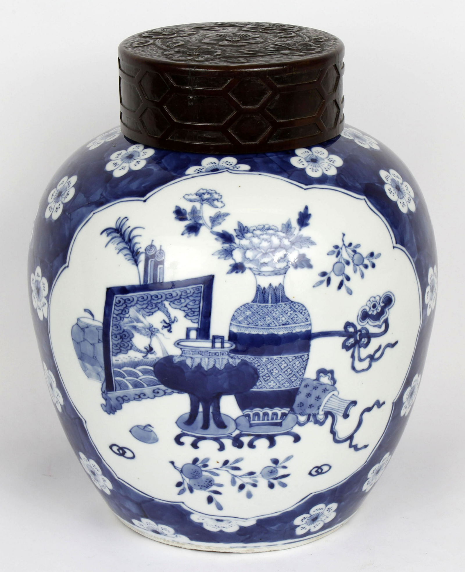 KANGXI STYLE I REVIVAL PRUNUS GINGER JAR: Kangxi / Kang-Hsi period(1662-1722) style, revival 1900, large ginger jar. Painted with blossoming prunus branches against a blue cracked ice patterned with associated wood cover. Signed on bottom bya