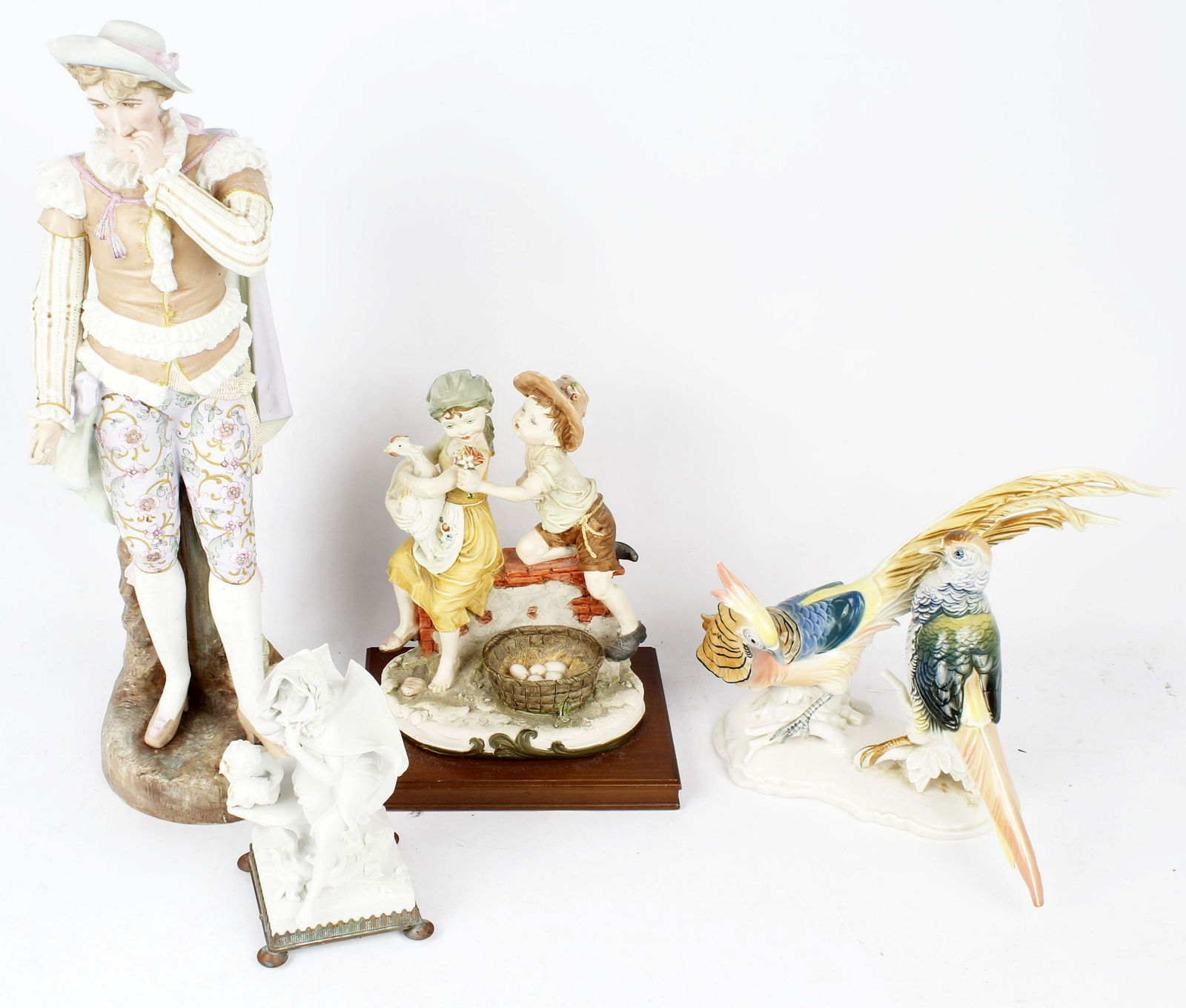 LOT OF FIGURINES INCLUDING GUISEPPE ARMANI: Giuseppe Armani boy and girl figurine mounted on base. Initials on figurine. 19" European male statue. Appears as though he was holding something in his hand (perhaps a mondolin) but is no longer ther