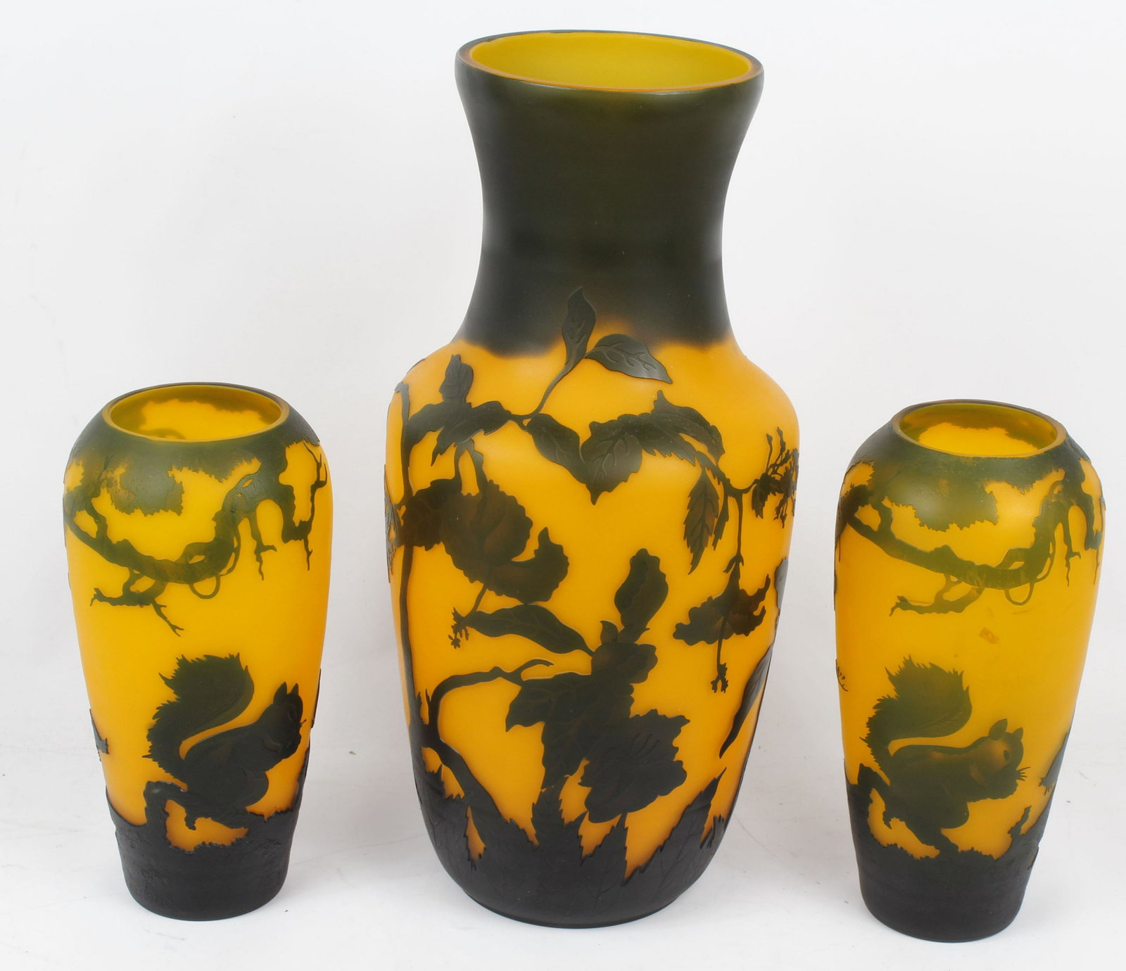 GALLE STYLE FRENCH CAMEO VASE LOT: Bulbous form in yellow / orange glass decorated with black. Small vases are a pair 11x5.5" with squirrel design and large vase 18x7" has a bird and hibiscus flowers. Condition: Very Fine