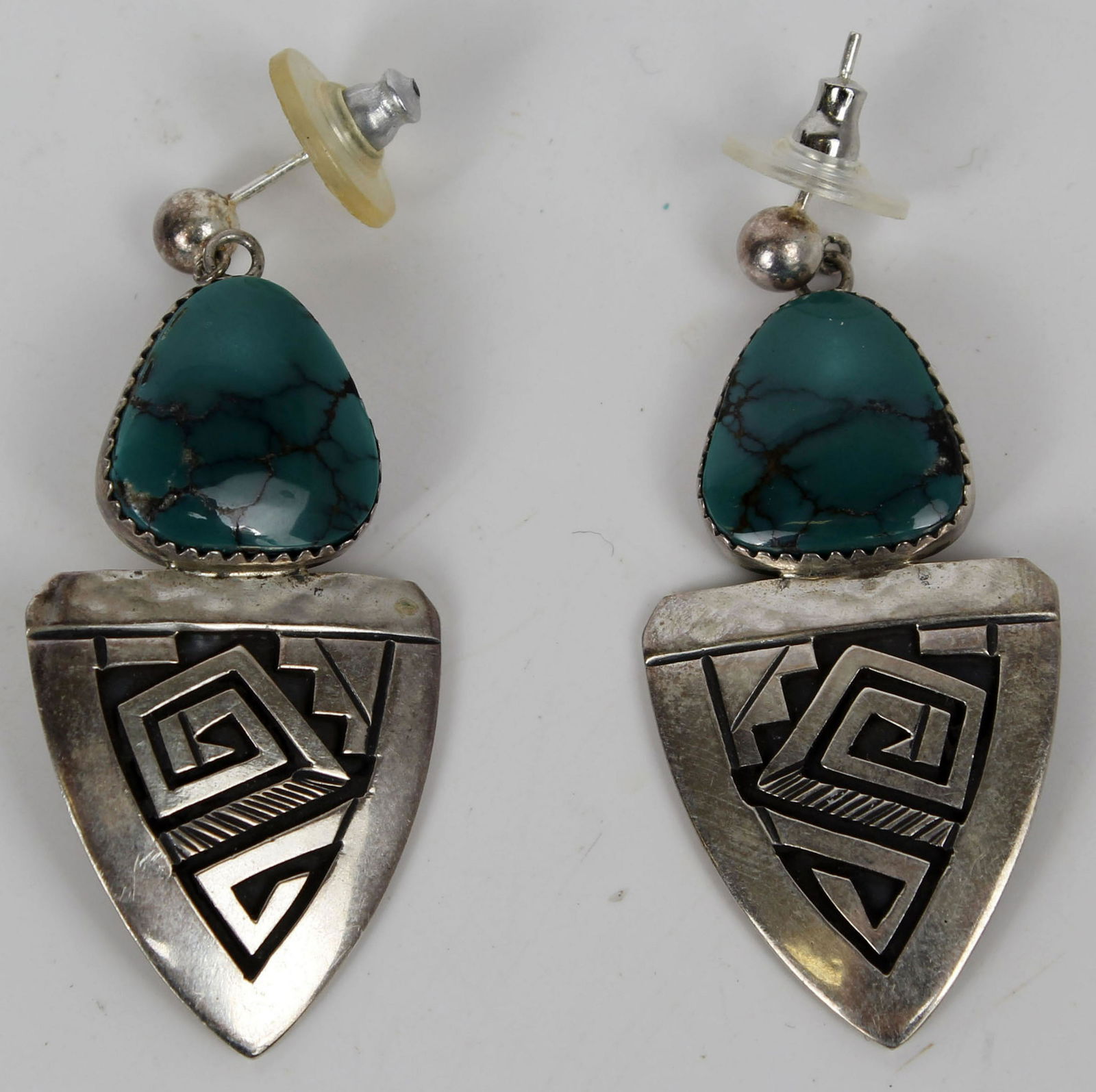 STERLING SILVER TURQUOISE PETER NELSON EARRINGS: Signed by Peter Nelson. Sterling Silver Dangle Earrings with Turquoise and Hand-Stamped Designs. Peter Nelson (B1954) is an award winningNavajo artist. Condition: Very Fine