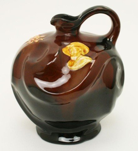WELLER POTTERY VASE WITH 19TH CENTURY FIGURE: WELLER POTTERY VASE WITH 19TH CENTURY FIGURE Narrow neck pitcher by Owen's for Weller. Decorated with two busts of what appears to be Buffalo Bill. 7 inches. VGC. Size: 7 Condition: VGC EST. $100-200