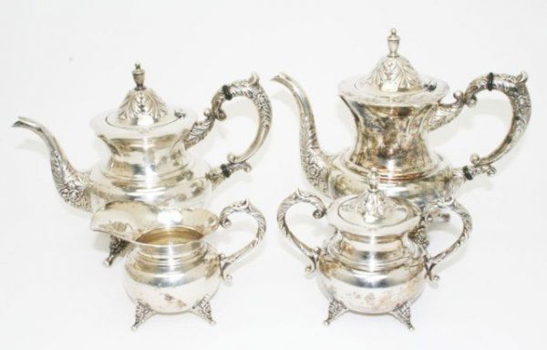 STERLING SILVER 4 PIECE TEA SET: STERLING SILVER 4 PIECE TEA SET Matching 4 piece tea set comprising tea (8 inches), coffee (9 inches) pots, creamer and sugar. All marked sterling. The lid to the coffee pot is detached. Total weight