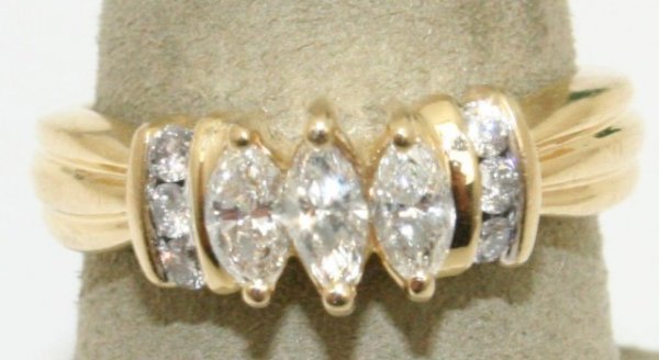 LADIES 14K GOLD 3/4 CTW MARQUISE DIAMOND RING: LADIES 14K GOLD 3/4 CTW MARQUISE DIAMOND RING A nicely finished ring with a center consisting of 3 - .2 Ct. marquise diamonds, accented by 3 - .03 Ct. round diamonds to each side. Approximately 3/4 CT