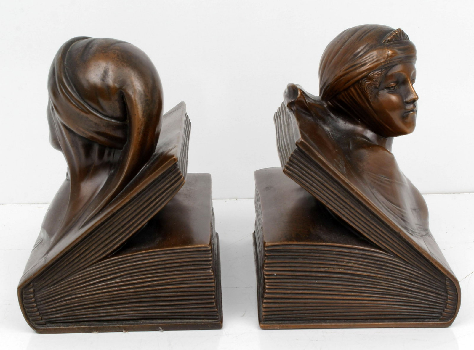 BEATRICE DANTE BOOK ENDS BRONZE: 115191BEATRICE DANTE BOOK ENDS BRONZE Dante & Beatrice on Open Book - Jennings Bros Circa 1935. Gray metal with beautiful deep chocolate bronze finish. 6” x 5-1/2”. Inscribed: JB2396 Pat.Appl’d.