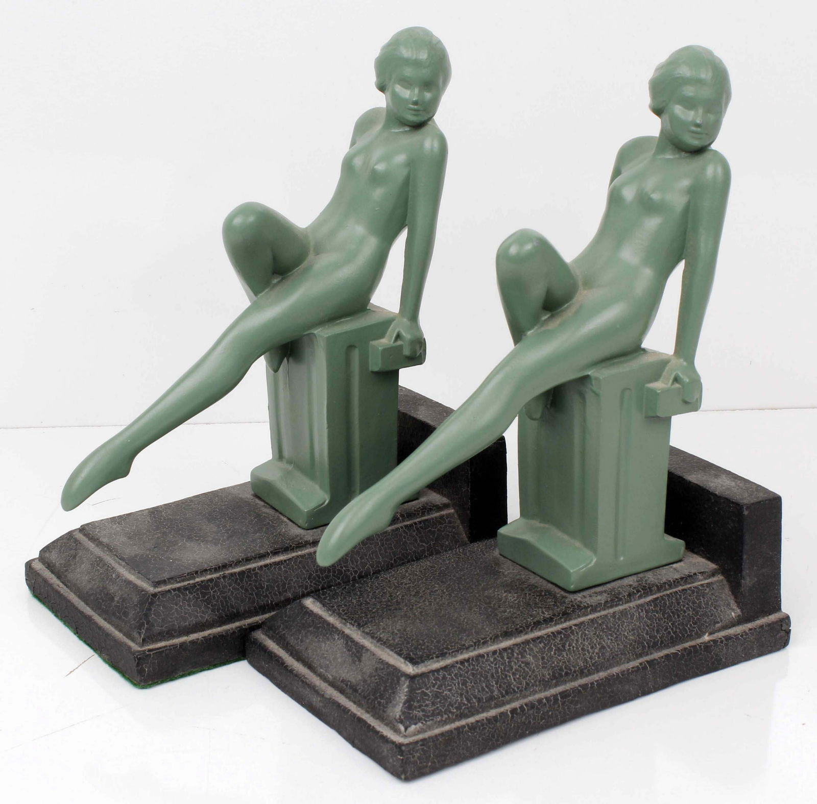 AFTER FRANKART ART DECO NOUVEAU FIGURAL BOOKENDS: 115235AFTER FRANKART ART DECO NOUVEAU FIGURAL BOOKENDS In the style of Frankart. Apple Green painted White metal Art Nouveau figural bookends. Nude woman leaning back on a pedestal. 8Hx6Dx3.5W Conditi