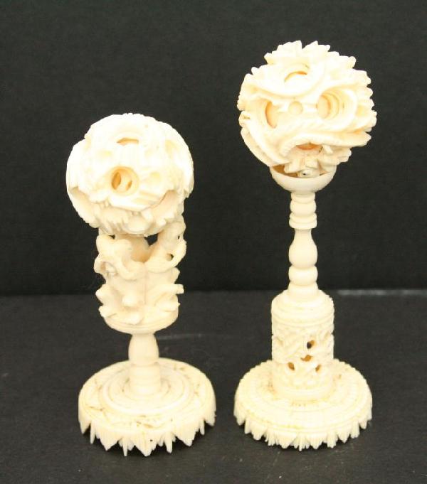 TWO CHINESE CARVED IVORY PUZZLE/MYSTERY BALLS: TWO CHINESE CARVED IVORY PUZZLE/MYSTERY BALLS Standing 4 and 3.5 inches tall. Size: See discription Condition: VGC EST. 100-200