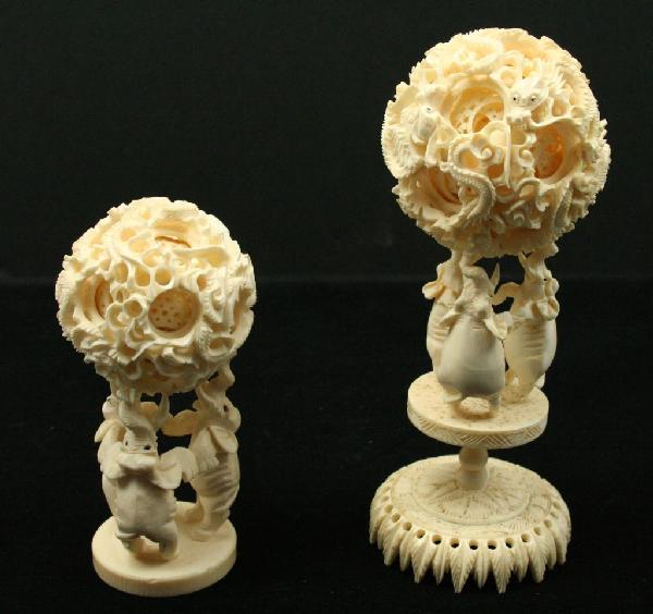 TWO VINTAGE CHINESE IVORY PUZZLE BALLS: TWO VINTAGE CHINESE IVORY PUZZLE BALLS Two ivory puzzle balls on Elephant stands. The smaller example with some damage to the inner balls. Size: 7" and 5" Condition: GC EST. 100-200