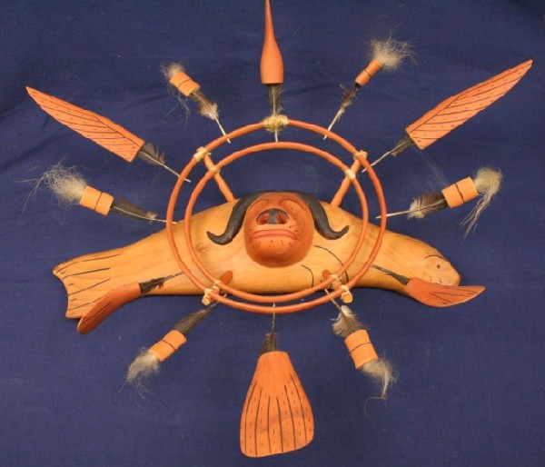 ALASKAN ESKIMO FISH BUFFALO & BIRD WALL MASK: ALASKAN ESKIMO FISH BUFFALO & BIRD WALL MASK Carved wood wall mask of a fish with buffalo head and bird surround. Bird feather arms with polar bear fur finials Size: 22" max Condition: VGC EST. $150-3