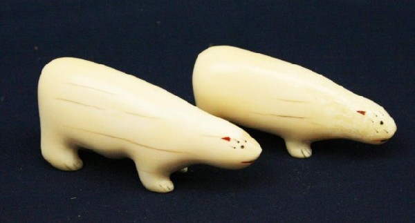TWO CARVED WALRUS TUSK IVORY POLAR BEARS: TWO CARVED WALRUS TUSK IVORY POLAR BEARS Two naive hand carved polar bears. Size: 2.5" & 3" long Condition: VGC EST. $100-200