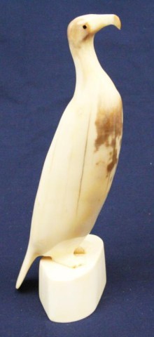 ALASKAN ESKIMO WALRUS TUSK IVORY CARVED BIRD: ALASKAN ESKIMO WALRUS TUSK IVORY CARVED BIRD A large walrus tusk bird standing 8.25 inches. Signed "Antogname". Size: 8.25" Condition: VGC EST. $150-300