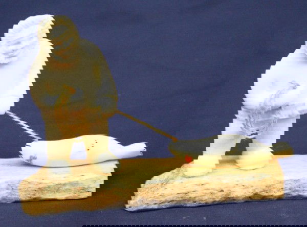 ALASKAN ESKIMO WALRUS IVORY TUSK SEAL HUNT CARVING: ALASKAN ESKIMO WALRUS IVORY TUSK SEAL HUNT CARVING A well carved Eskimo diorama of a seal hunter. Walrus tusk carving on a bone base. Size: 4" tall Condition: VGC EST. $200-300
