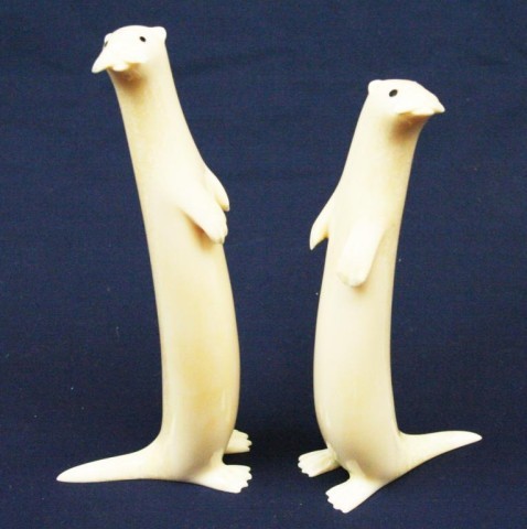 TWO ALASKAN WALRUS TUSK IVORY CARVED OTTERS: TWO ALASKAN WALRUS TUSK IVORY CARVED OTTERS Two carved ivory otters. Both are signed by the artist. Size: 5.5" & 6" Condition: VGC EST. $200-300