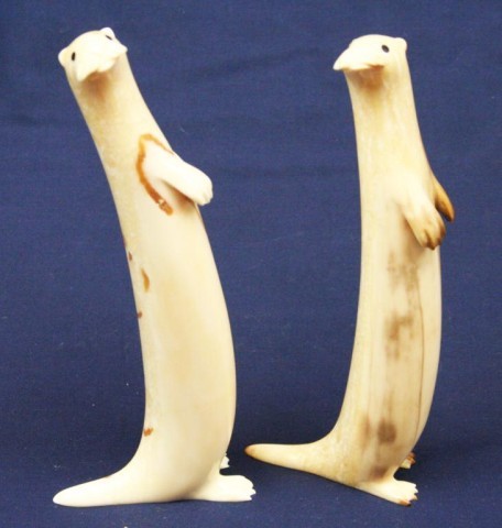 TWO ALASKAN WALRUS TUSK IVORY CARVED OTTERS: TWO ALASKAN WALRUS TUSK IVORY CARVED OTTERS Two large carved ivory otters. Both are signed by the artist. Size: 6" & 6.5" Condition: VGC EST. $200-400