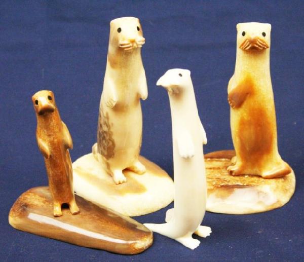 ALASKAN WALRUS TUSK IVORY CARVED OTTERS: ALASKAN WALRUS TUSK IVORY CARVED OTTERS A lot of 4 carved ivory otters. All are signed by the artist. Size: 3.25" to 4.5" Condition: VGC EST. $200-400