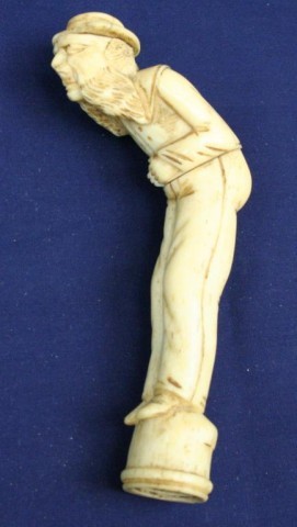 WALRUS TUSK IVORY WALKING CANE HANDLE: WALRUS TUSK IVORY WALKING CANE HANDLE Carved in the form of a 19th century sailor. Some light damage. Size: 5" Condition: VGC EST. $100-300