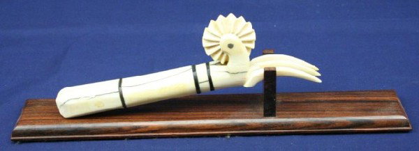 19TH CENTURY WALRUS TUSK IVORY & PIE CRIMPER: 19TH CENTURY WALRUS TUSK IVORY & PIE CRIMPER Walrus tusk ivory and baleen fork and pie crimper. Mounted to a wood display stand. Size: 8" Condition: VGC EST. $150-300