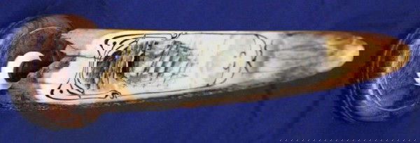 OLD WALRUS TUSK SCRIMSHAW WITH TINTED PICTURE: OLD WALRUS TUSK SCRIMSHAW WITH TINTED PICTURE A very old tusk with a good old age patina. The modern scrimshaw is of a ship in full sail, lightly colored to areas. Mounted to a wood stand. Size: 9.5"