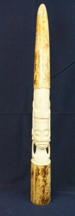 AFRICAN IVORY ELEPHANT TUSK TRIBAL CARVING: AFRICAN IVORY ELEPHANT TUSK TRIBAL CARVING Antique African elephant ivory tusk of 18 inches with a tribal deity figural carving. The tusk shows some age cracking. Size: 18" Condition: VGC Est. 150-300
