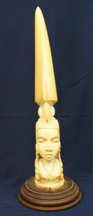 LARGE AFRICAN ELEPHANT TUSK IVORY CARVING DEITY: LARGE AFRICAN ELEPHANT TUSK IVORY CARVING DEITY A large and well executed ivory tusk carving of a tribal deity figure. The tusk stands 23.5 inches including the wood base. Almost 11 inch circumference