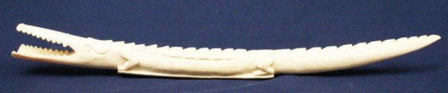 ELEPHANT IVORY TUSK CARVED CROCODILE: ELEPHANT IVORY TUSK CARVED CROCODILE A native African carved ivory crocodile. Unsigned. Size: 24.5" Condition: VGC Est. 600-1000