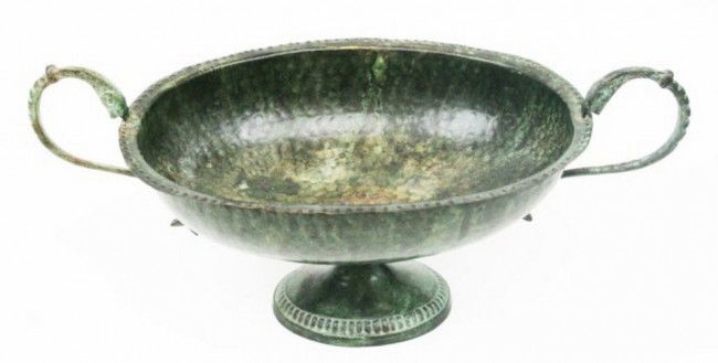 HAMMERED BRONZE BOWL CENTER PIECE C1600: HAMMERED BRONZE BOWL CENTER PIECE C1600 Thin sheet hammered bronze bowl, Roman in appearance, but probably 17th century. Surreal fish design handles and fluted stem foot. Size 12 x 6 x 7.5 inches. Siz