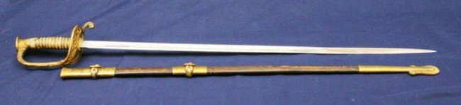 LATE 19TH CENTURY US NAVY OFFICERS DRESS SWORD: LATE 19TH CENTURY US NAVY OFFICERS DRESS SWORD Etched blade of 29.75 inches named to Waldenar Nielson. Gilt fittings and shagreen grip. Leather scabbard with gilt fittings, all parts are stamped "68".