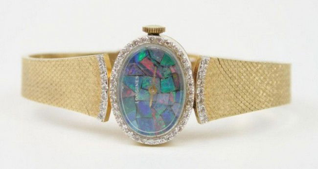 LONGINES LADIES 14K WRISTWATCH OPAL DIAL DIAMONDS: LONGINES LADIES 14K WRISTWATCH OPAL DIAL DIAMONDS 14k yellow gold case and bracelet, approx. 50 round brilliant cut diamonds of approx. 1pt each surround the mosaic opal dial, 17 jewel works, model 50
