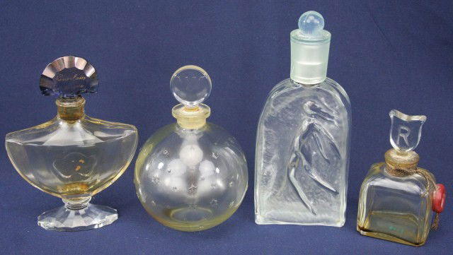 LOT 4 COLLECTIBLE GLASS PERFUME BOTTLES: LOT 4 COLLECTIBLE GLASS PERFUME BOTTLES To include the following bottles: 1.7 fluid ounce Rochas - French molded frosted glass with nude woman & pump top, 4.2 fluid ounce by Baccarat for Guerlain - Fr