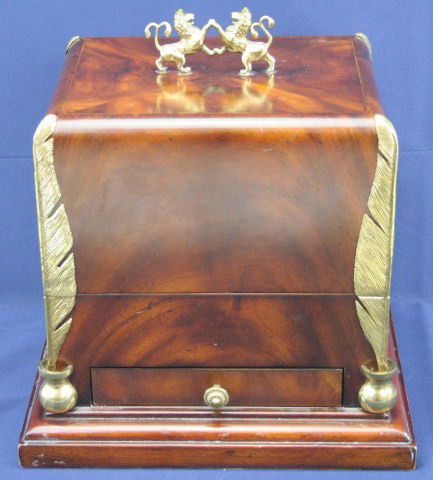MAITLAND SMITH BURL WALNUT WRITING BOX: MAITLAND SMITH BURL WALNUT WRITING BOX Maitland-Smith burl walnut writing box embellished on the sides with brass quills and inkwells. On top sits two fighting lions. Size: 12.25"x13.5"x10.5" Conditio