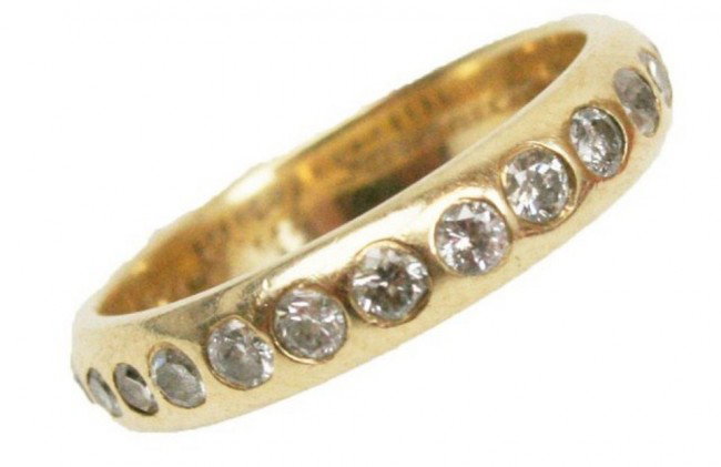 TIFFANY & CO LADIES 14K GOLD & DIAMOND RING: TIFFANY & CO LADIES 14K GOLD & DIAMOND RING Plain 14k yellow gold band with 15 round cut, inset diamonds. The inner band is engraved "14k Tiffany & Co. 12.8.69". Contained in it's original Tiffany box