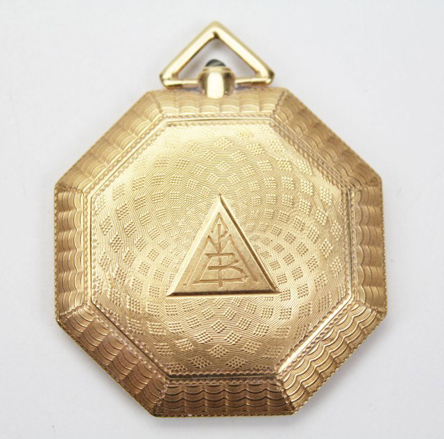 14K ART NOUVEAU MAKEUP COMPACT: 14K ART NOUVEAU MAKEUP COMPACT Hexagonal compact decorated with Florentine finish in alternating swirl designs. Blue sapphire cabochon gem closure and triangular bow for chain suspension. Outstanding 