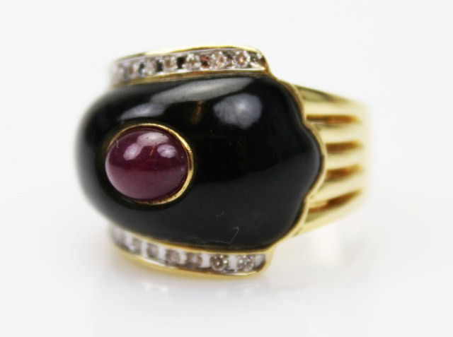 VAN CLEEF STYLE 18K RUBY & ONYX RING: VAN CLEEF STYLE 18K RUBY & ONYX RING A wave of black onyx channeled by 1.00ct in F color and VS clarity diamonds, break over an intense red 4 x 6mm cabochon ruby. Hand crafted mid-20th century design.