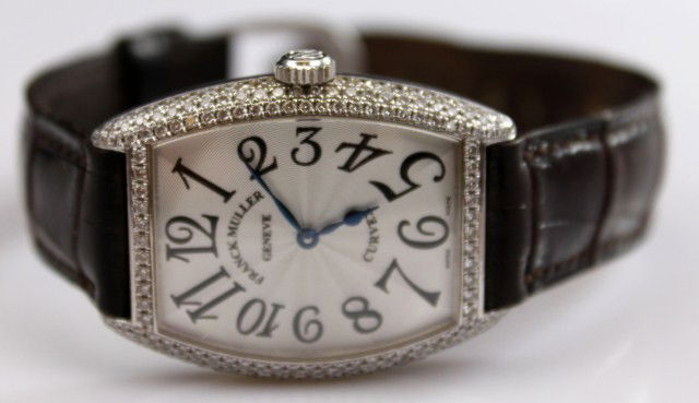 MENS FRANCK MULLER GENEVE DIAMOND WRISTWATCH: A Franck Muller wristwatch with diamond bezel. Approximately 3 Ctw in diamonds. 18K white gold case. Model number 7502 QZ D #245. Leather band. Also included is the original burl walnut box. Condition