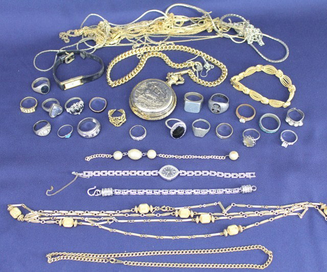 COSTUME JEWELRY LOT:RINGS,POCKET WATCH,& NECKLACES: Costume jewelry lot including various sized rings, a pocket watch, necklaces, and bracelets. A few of the pieces are sterling silver and at least one piece is Monet. Weight: 0.96 lb Condition: VGC