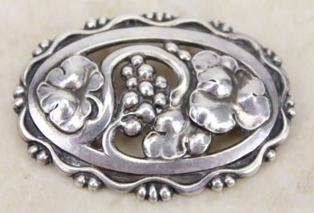 GEORG JENSEN EARLY 20TH C. STERLING FLORAL BROOCH: A very nice early Georg Jensen sterling silver brooch. Floral & grape motif. Mark dates to early 20th C., making this a more desirable Georg Jensen collectible jewelry piece. Weight: 23 grams Size: 2.