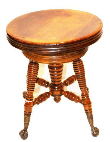 ANTIQUE WOODEN PIANO STOOL: ANTIQUE WOODEN PIANO STOOL Wooden swivel piano stool with metal clawed feet on balls. Size: 17" Condition: GC Lot: 15326a