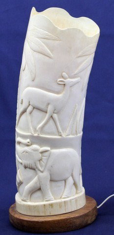 CARVED AFRICAN ELEPHANT IVORY LAMP: CARVED AFRICAN ELEPHANT IVORY LAMP An adult elephant tusk section, carved and affixed to a base with a lamp attached. Size: 14" tall total Condition: VGC Lot: 15378