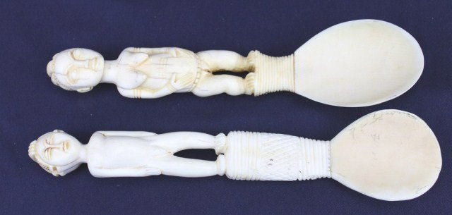 PAIR OF IVORY COAST CARVED IVORY SPOONS: PAIR OF IVORY COAST CARVED IVORY SPOONS A pair of fertility type spoons carved from African elephant ivory. Male and female characters. Size: 9" Condition: Some age stress fractures Lot: 15379