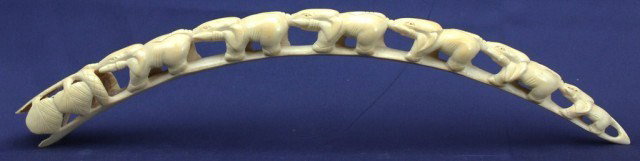 AFRICAN CARVED IVORY TUSK BRIGE OF ELEPHANTS: AFRICAN CARVED IVORY TUSK BRIGE OF ELEPHANTS A procession of six carved elephants carved from a juveniles tusk. Size: 22 inches long Lot: 15388